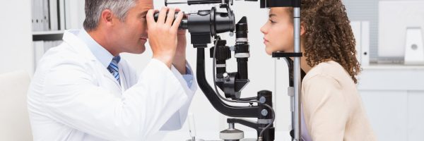 Woman doing eye test with optometrist in medical office