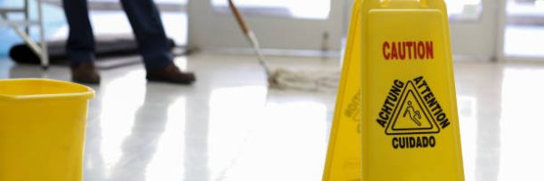 Senior adult Janitor keeps the floors cleaned and sanitized due to the virus.