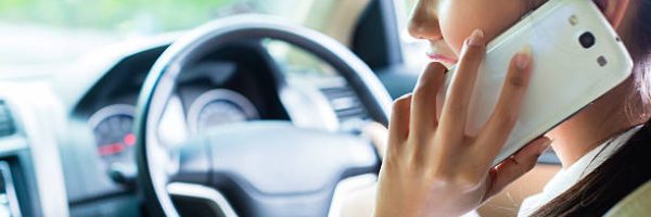 Asian Chinese young woman telephoning with mobile phone or smartphone while driving car