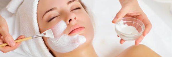 Woman in mask on face in spa beauty salon.